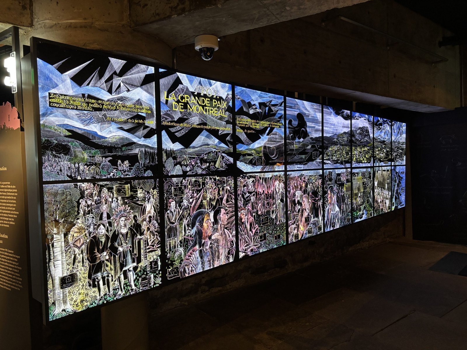 Large backlit mural illustrating the signing of the Great Peace of Montreal with Indigenous and French figures.