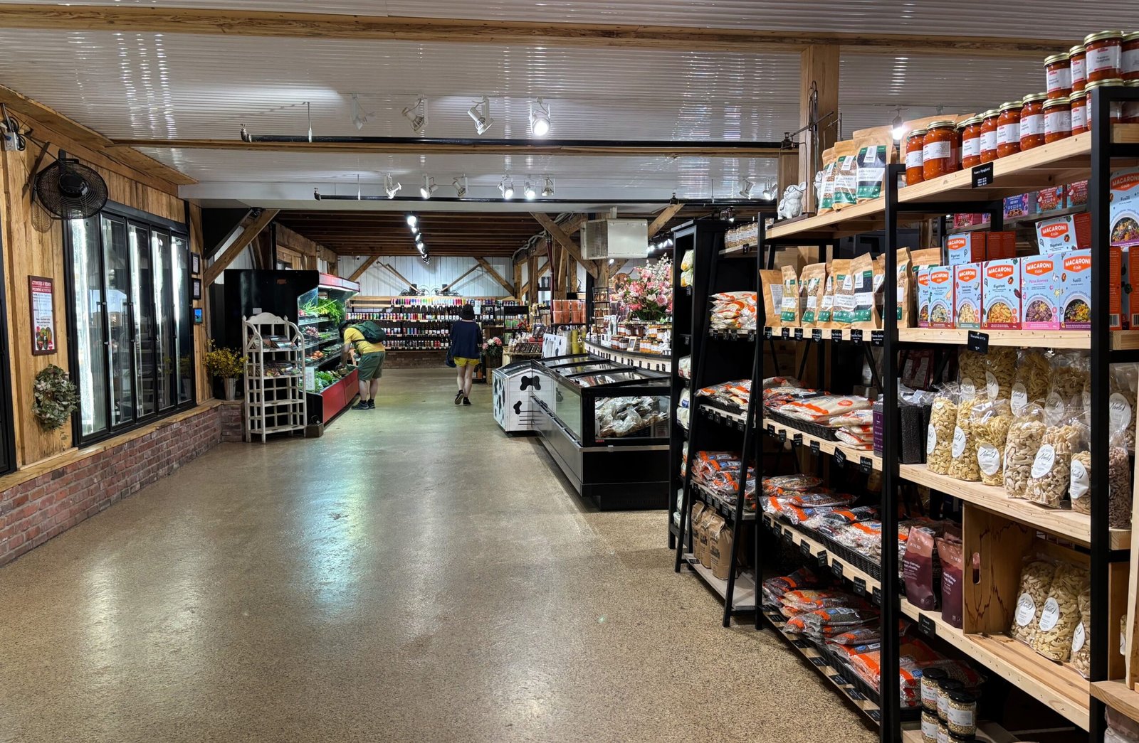 Interior view of the Quinn Farm grocery market with shelves and fridge sections.