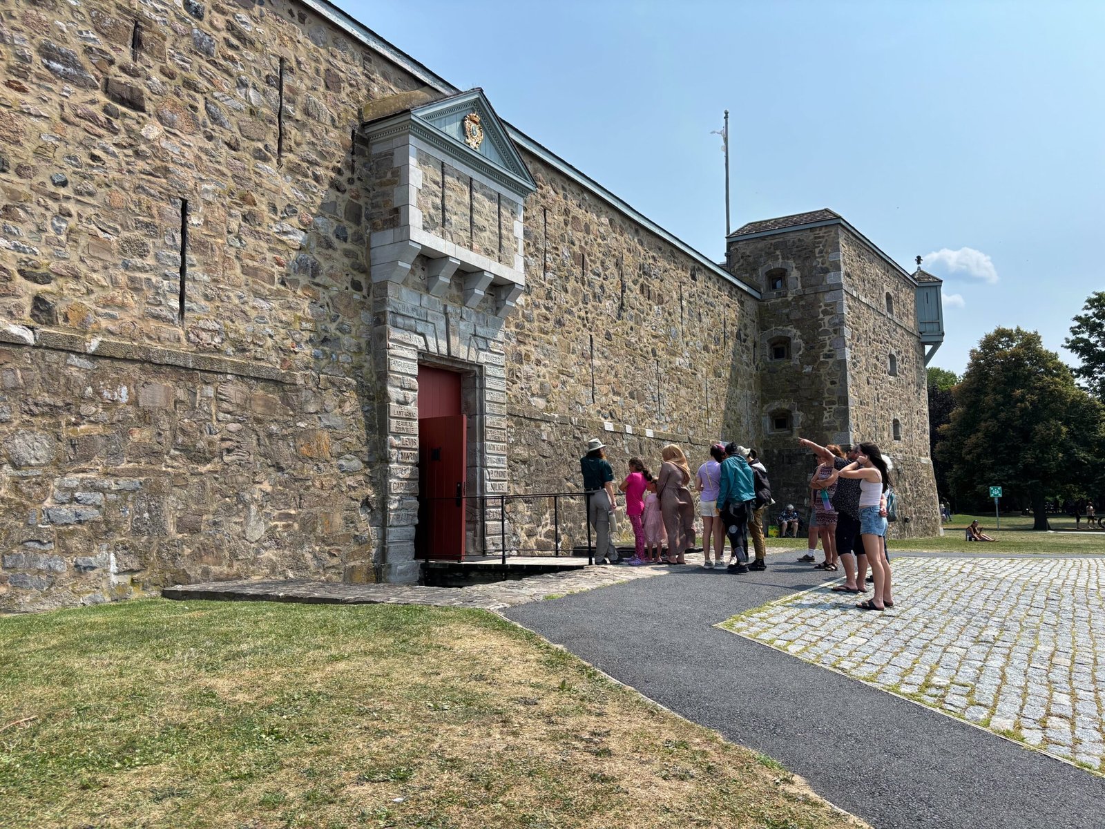 Tour group entering Fort de Chambly through the main stone gate, Quebec historic site.