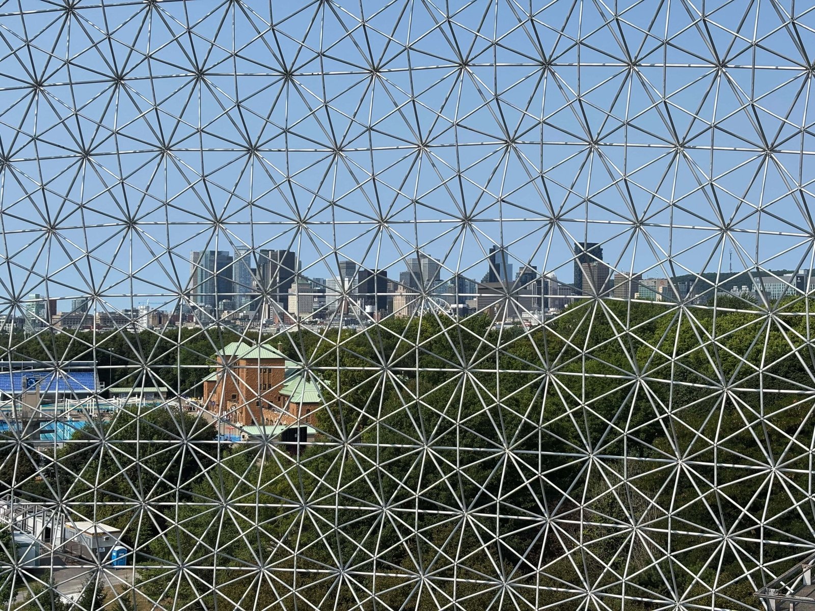 View of downtown Montreal skyline through the geodesic dome of the Biosphere.
