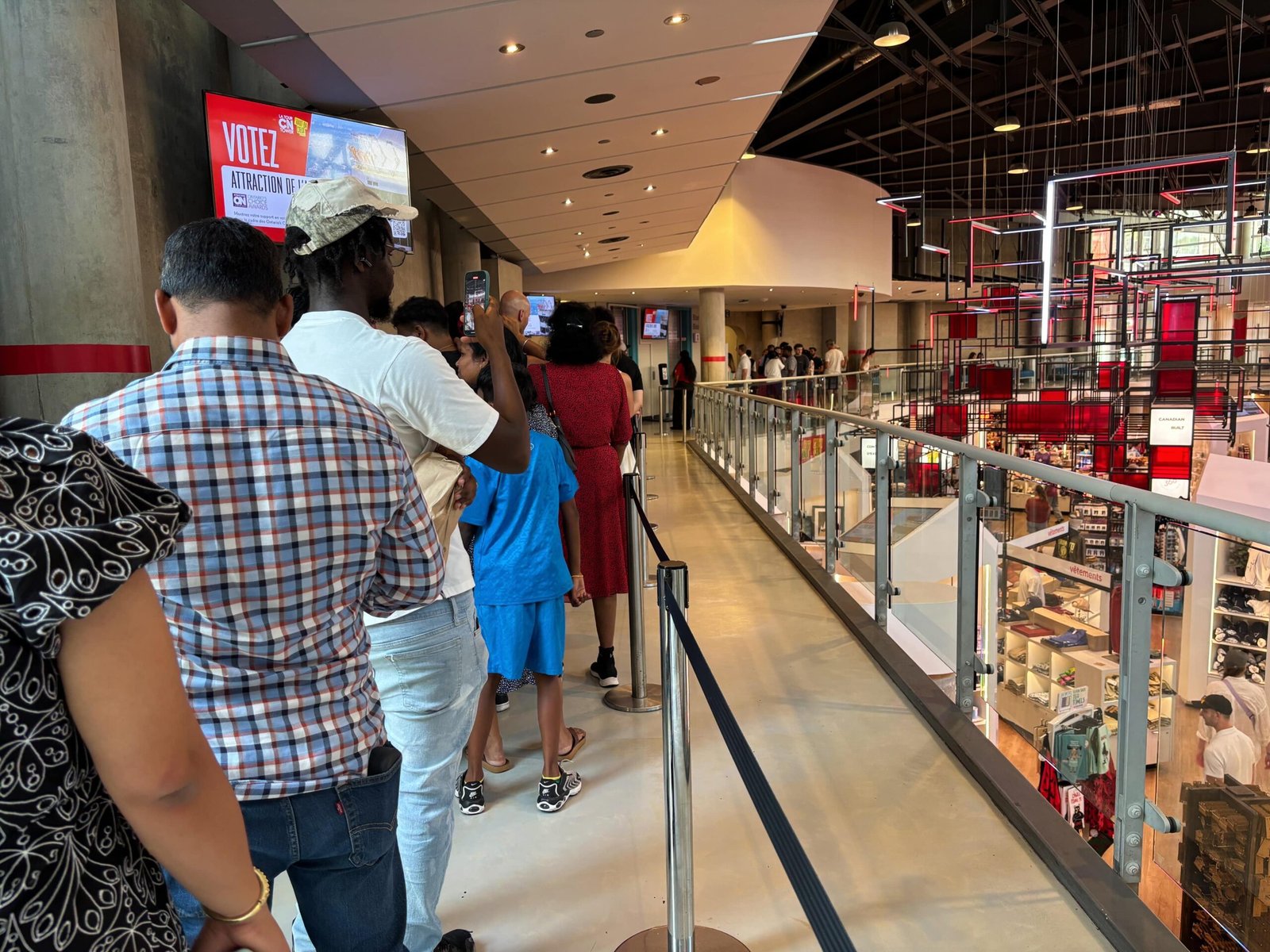 Line of visitors waiting inside the CN Tower lobby area.
