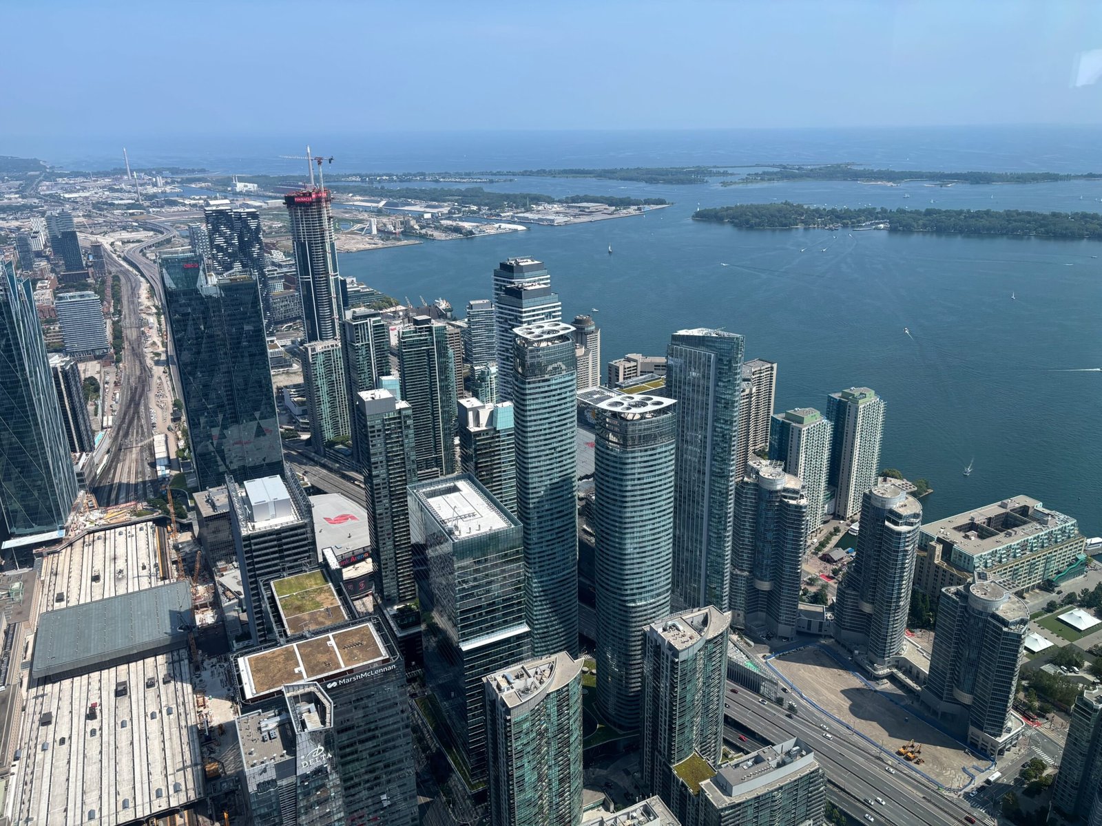 South-facing view from the CN Tower overlooking Lake Ontario and modern high-rises.