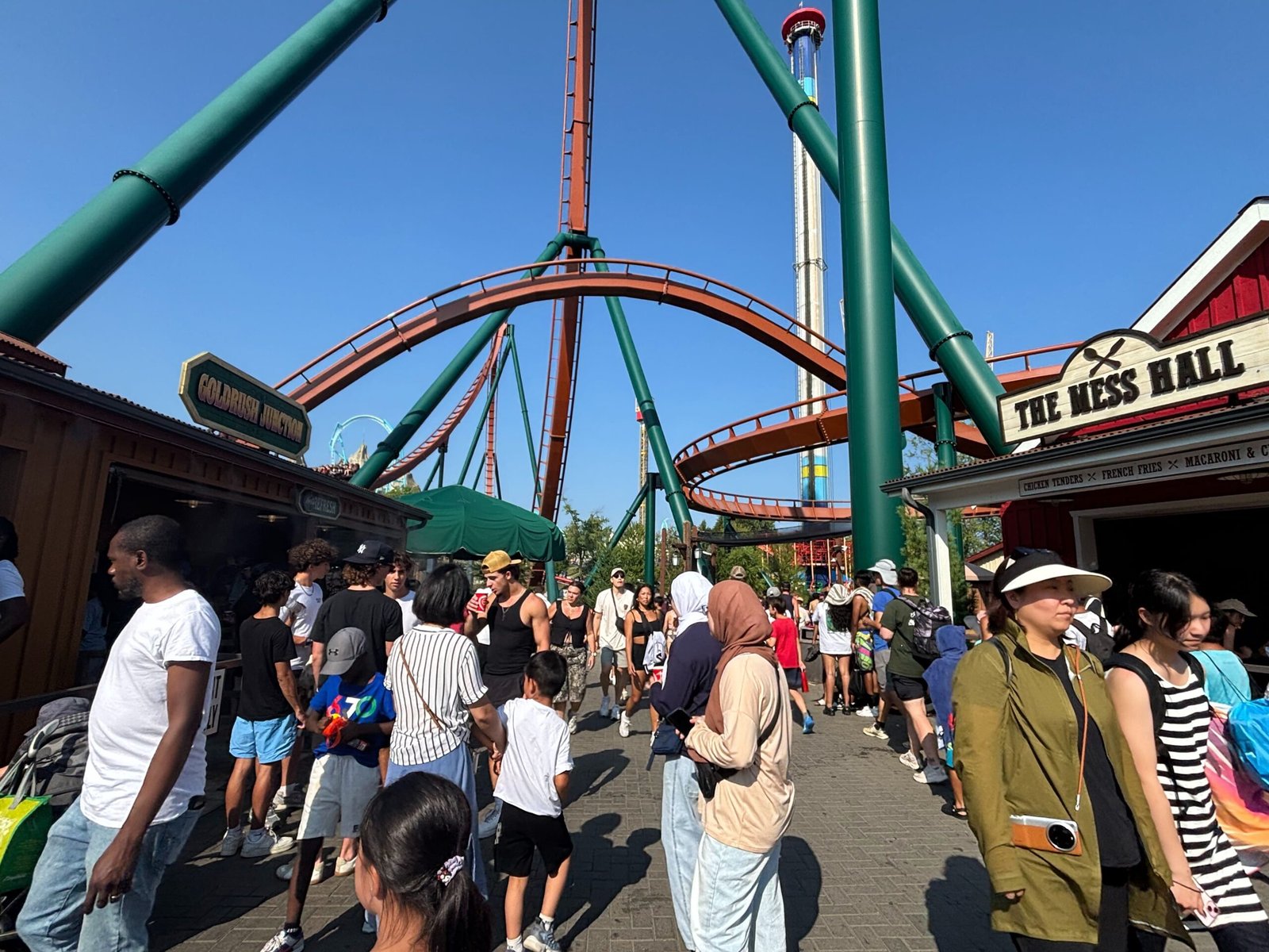 Crowds near roller coaster tracks and food stalls at Canada’s Wonderland.