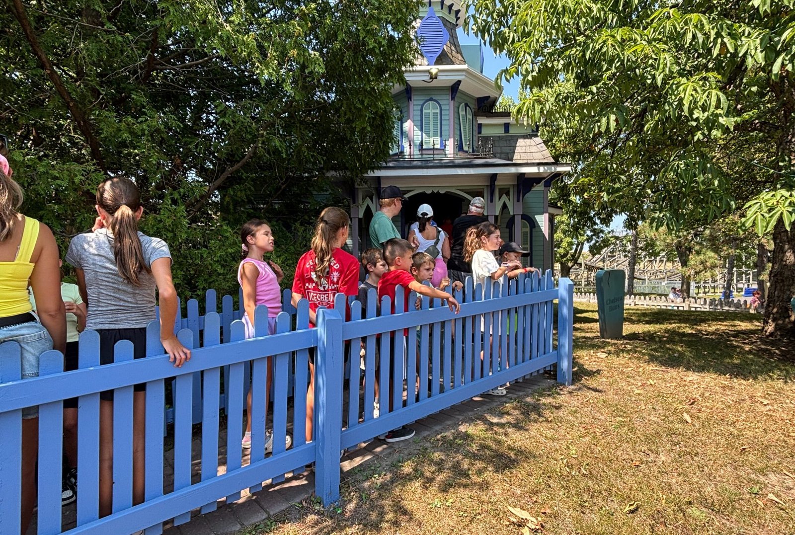 Children lined up outside a colourful playhouse ride at Canada’s Wonderland.