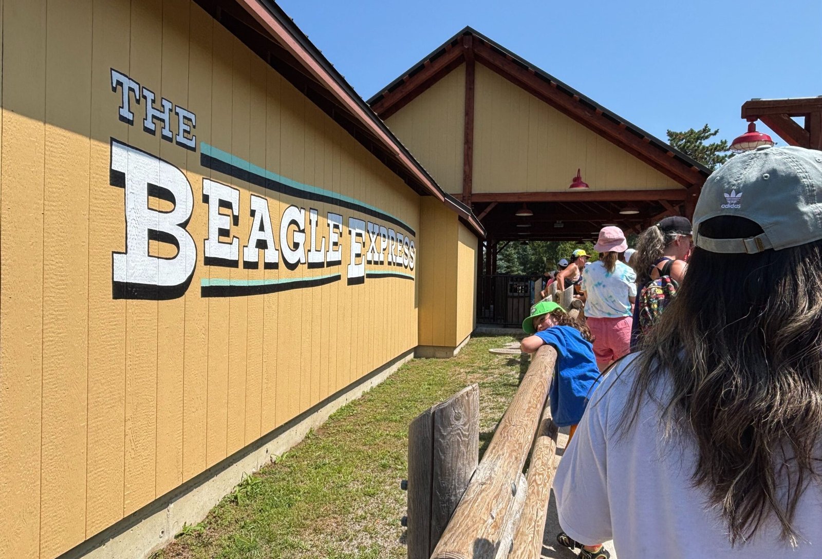 Families waiting in line at The Beagle Express train ride in Planet Snoopy.
