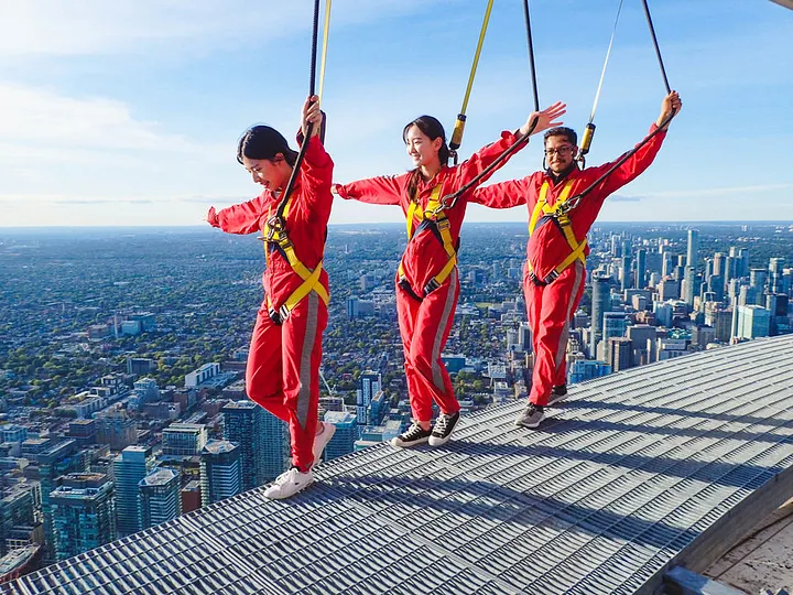 Persons experiencing the edgewalk on top of the CN tower