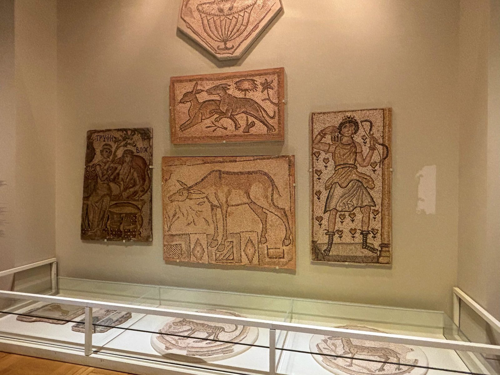 Ancient Roman mosaics displayed on a wall inside the Royal Ontario Museum.