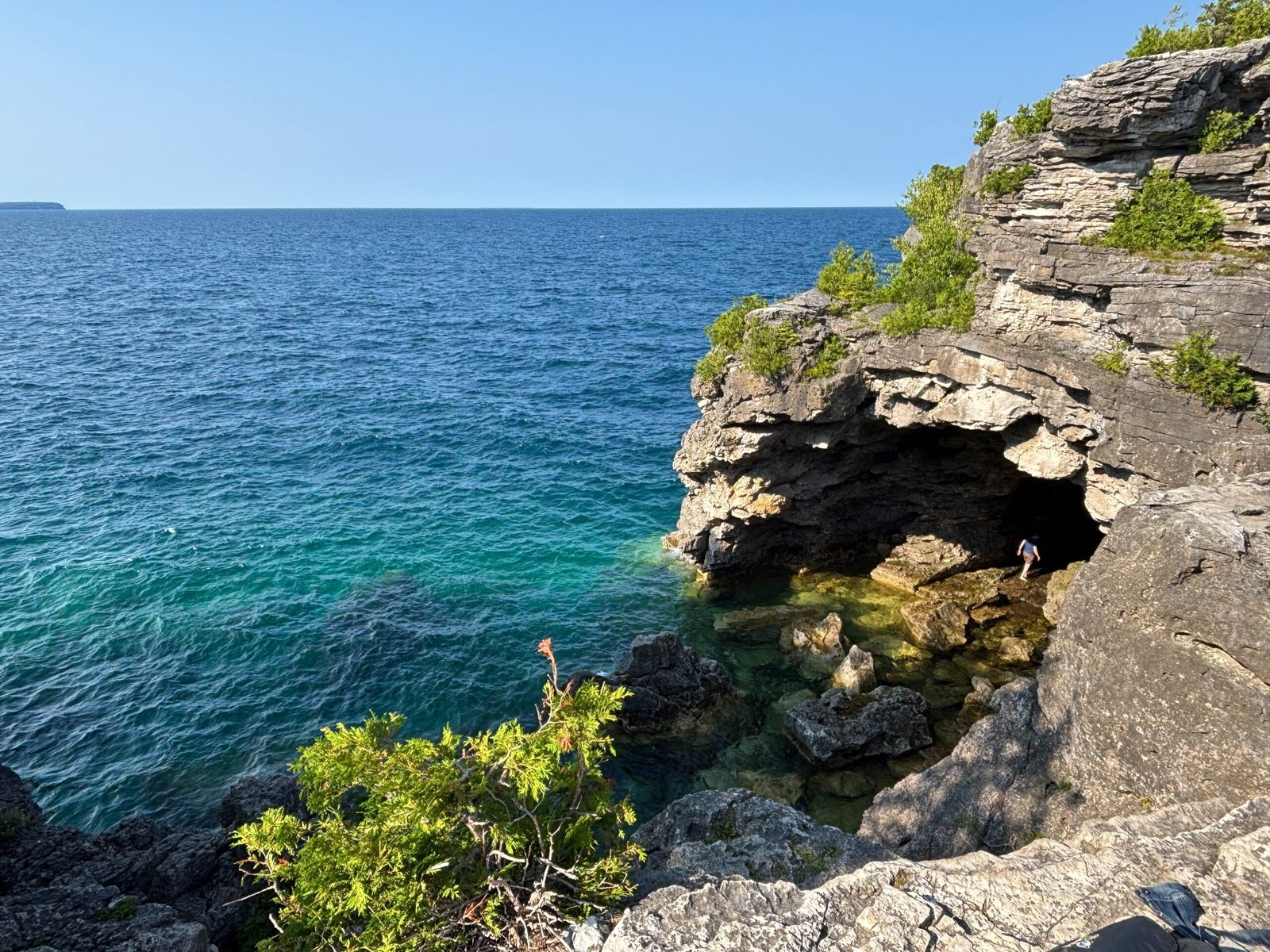 Rocky cave opening at the Grotto in Bruce Peninsula National Park, with turquoise water entering the cavern.