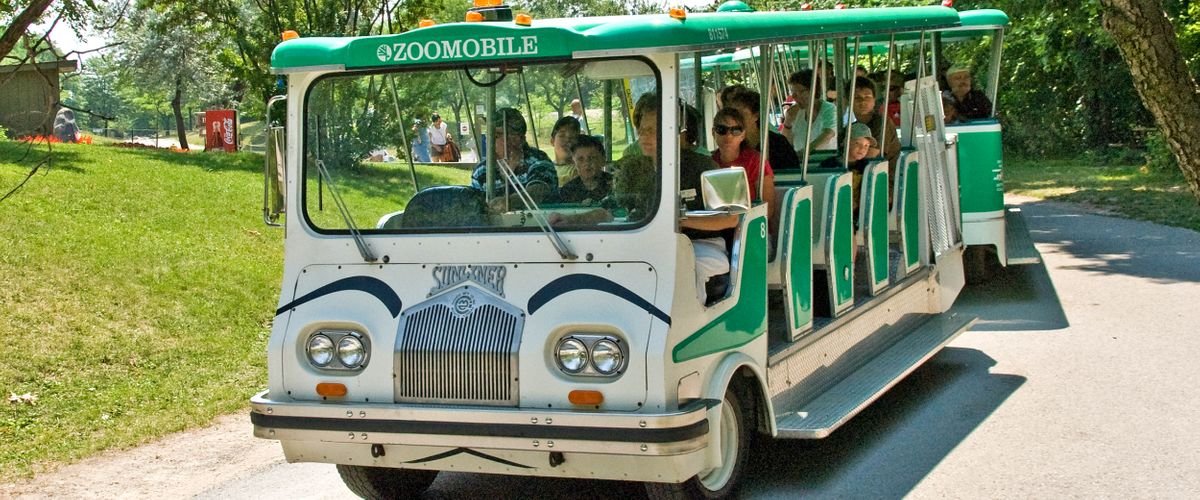 a zoomobile in toronto zoo with guests on board
