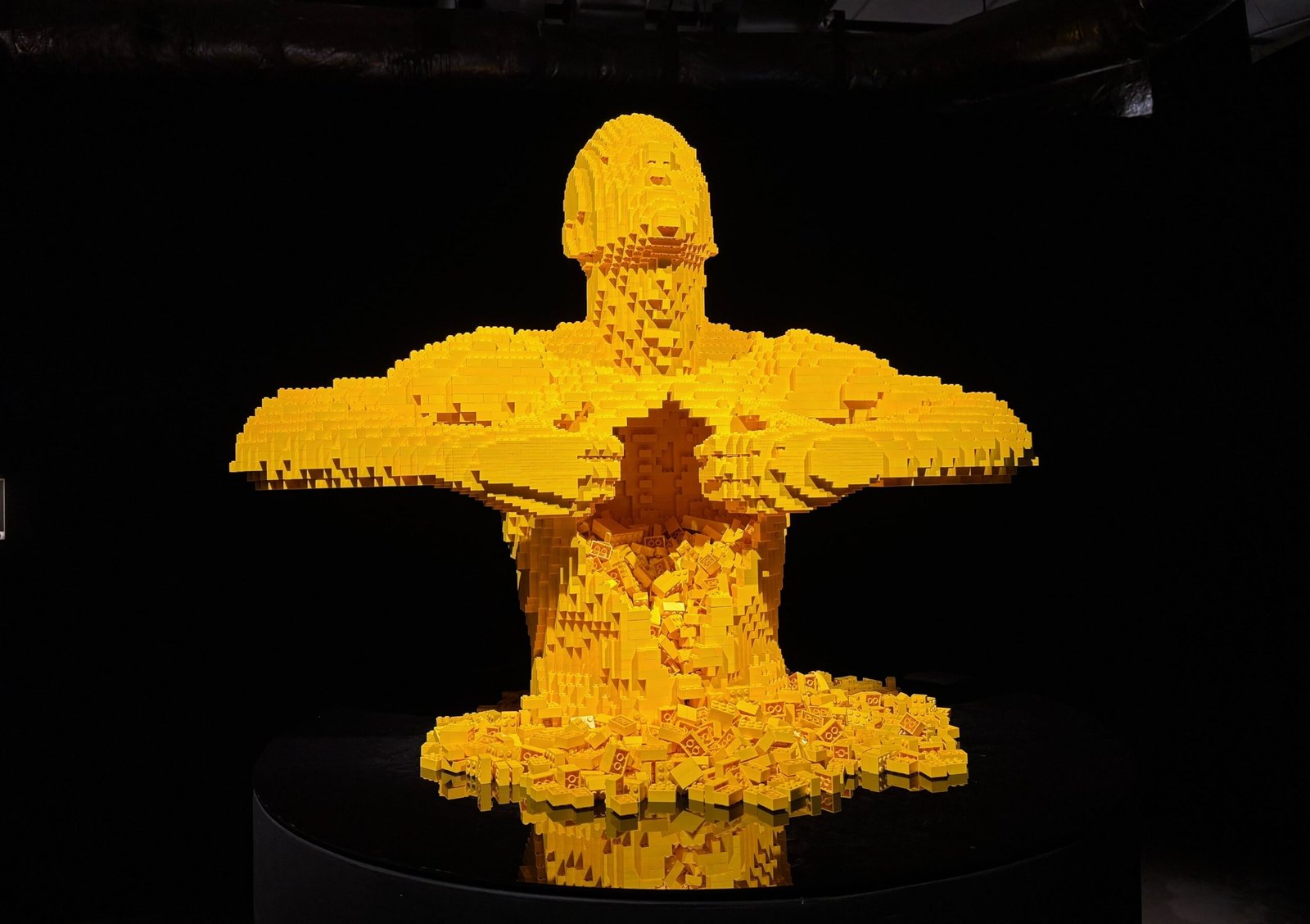 Striking wide view of the famous “Yellow” LEGO sculpture at Montreal’s Art of the Brick Expo, showcasing emotional expression through bricks.