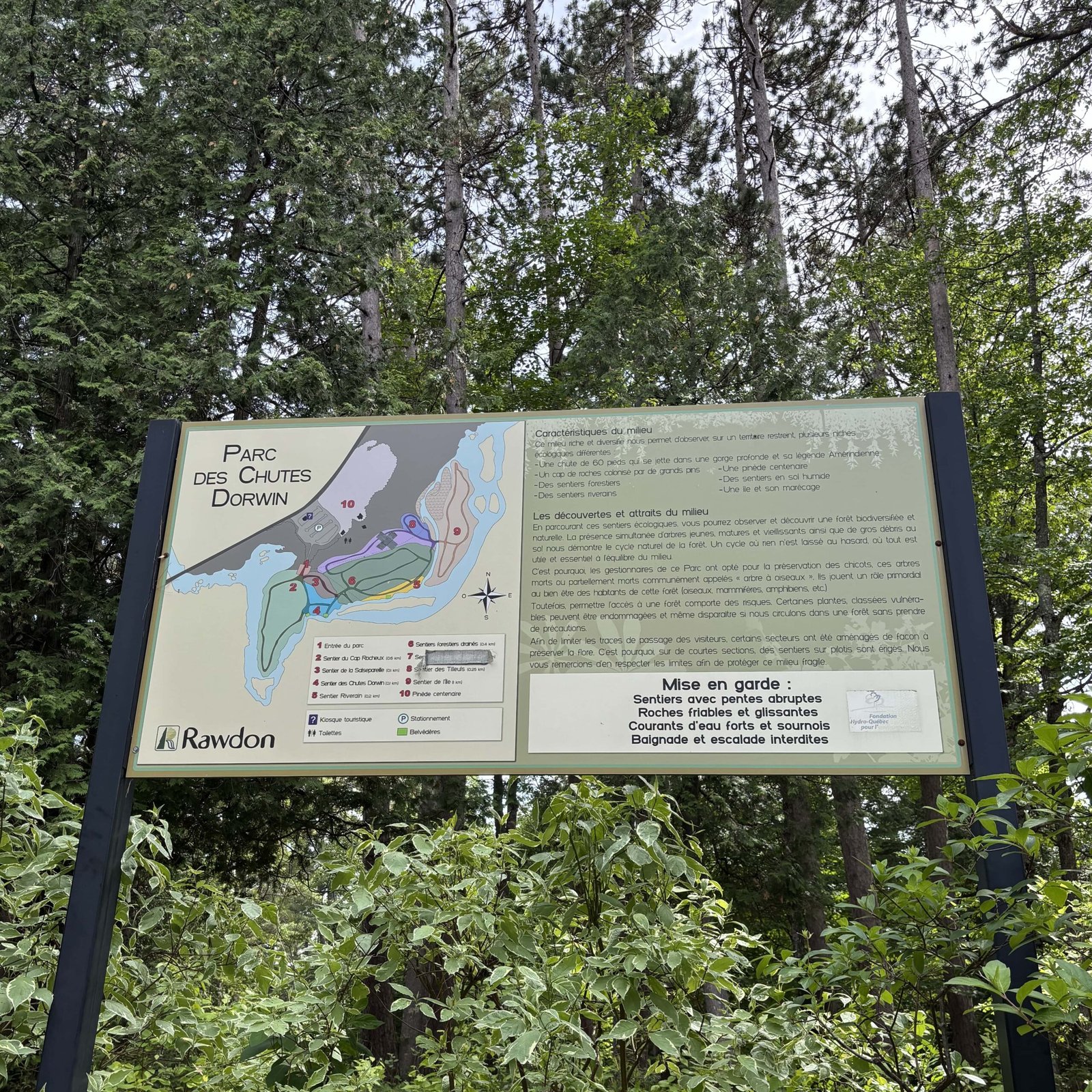 Informational sign with map and safety tips at the entrance of Dorwin Falls Park in Rawdon.