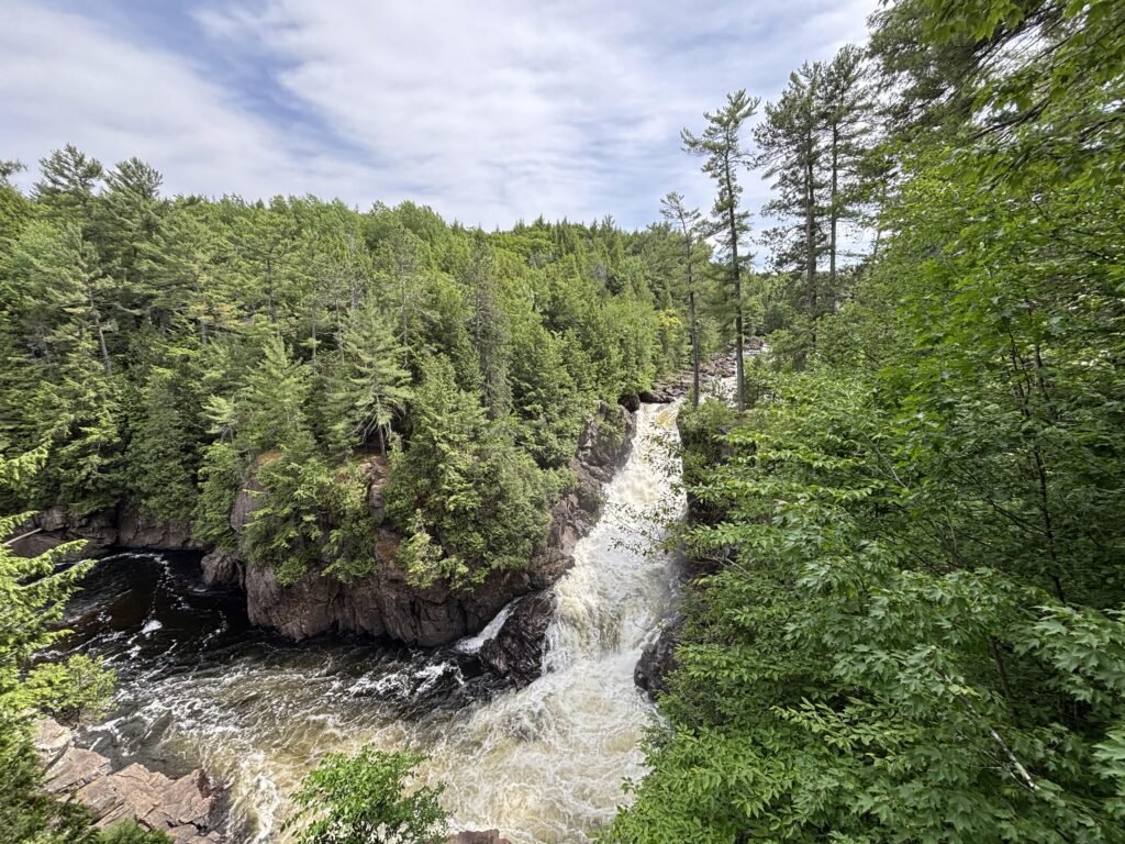 Aerial view of Dorwin Falls waterfall flowing through a tree-covered canyon in Quebec.