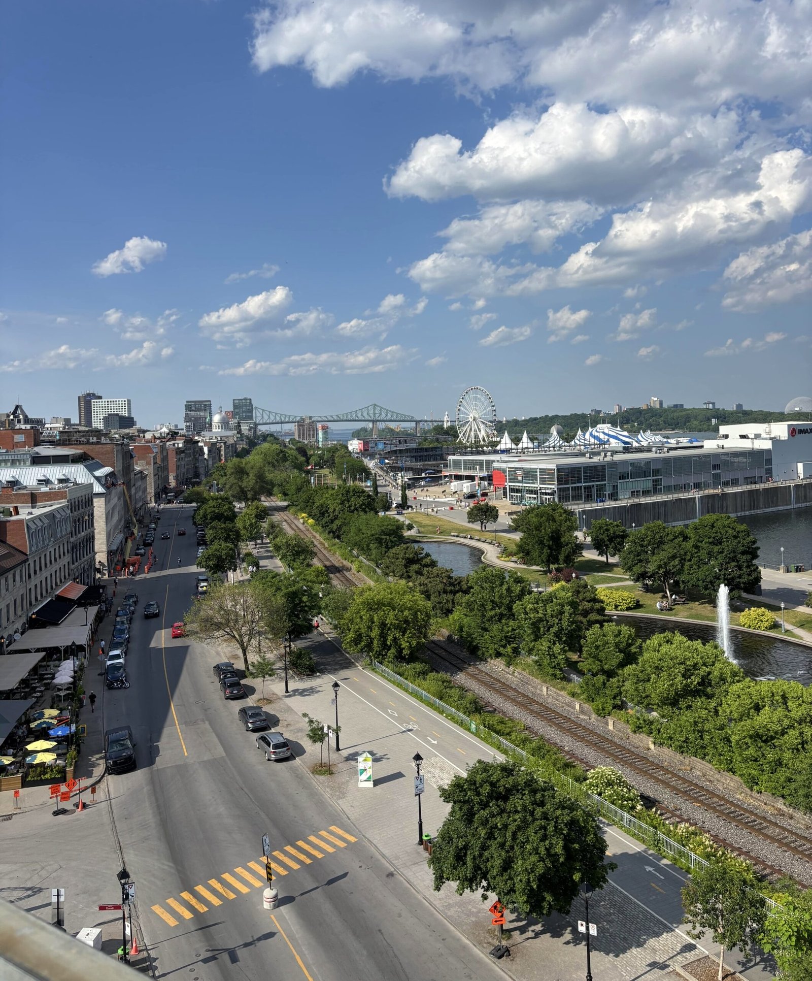 View of Old Port Montreal with La Grande Roue Ferris wheel and the Jacques Cartier Bridge in the distance.