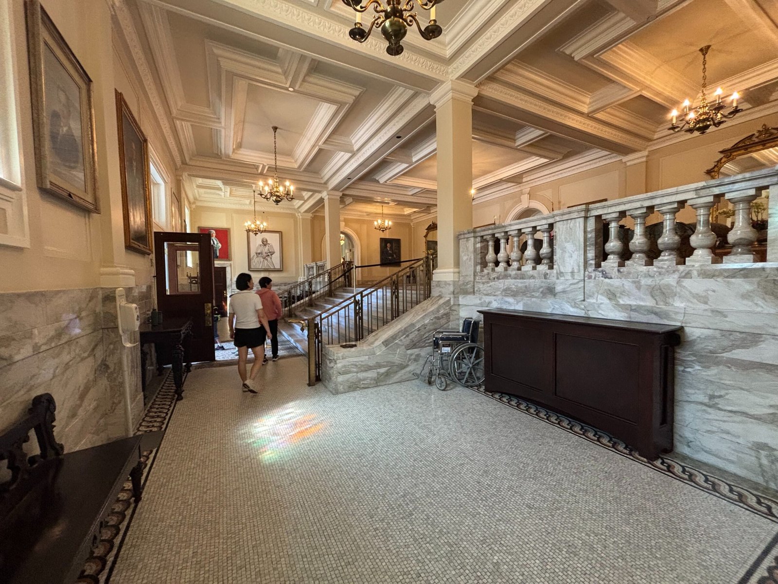 Ornate marble hallway inside Rideau Hall with chandeliers and historic details