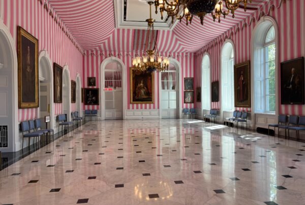 Wide view of the Tent Room at Rideau Hall with striped walls and chandeliers