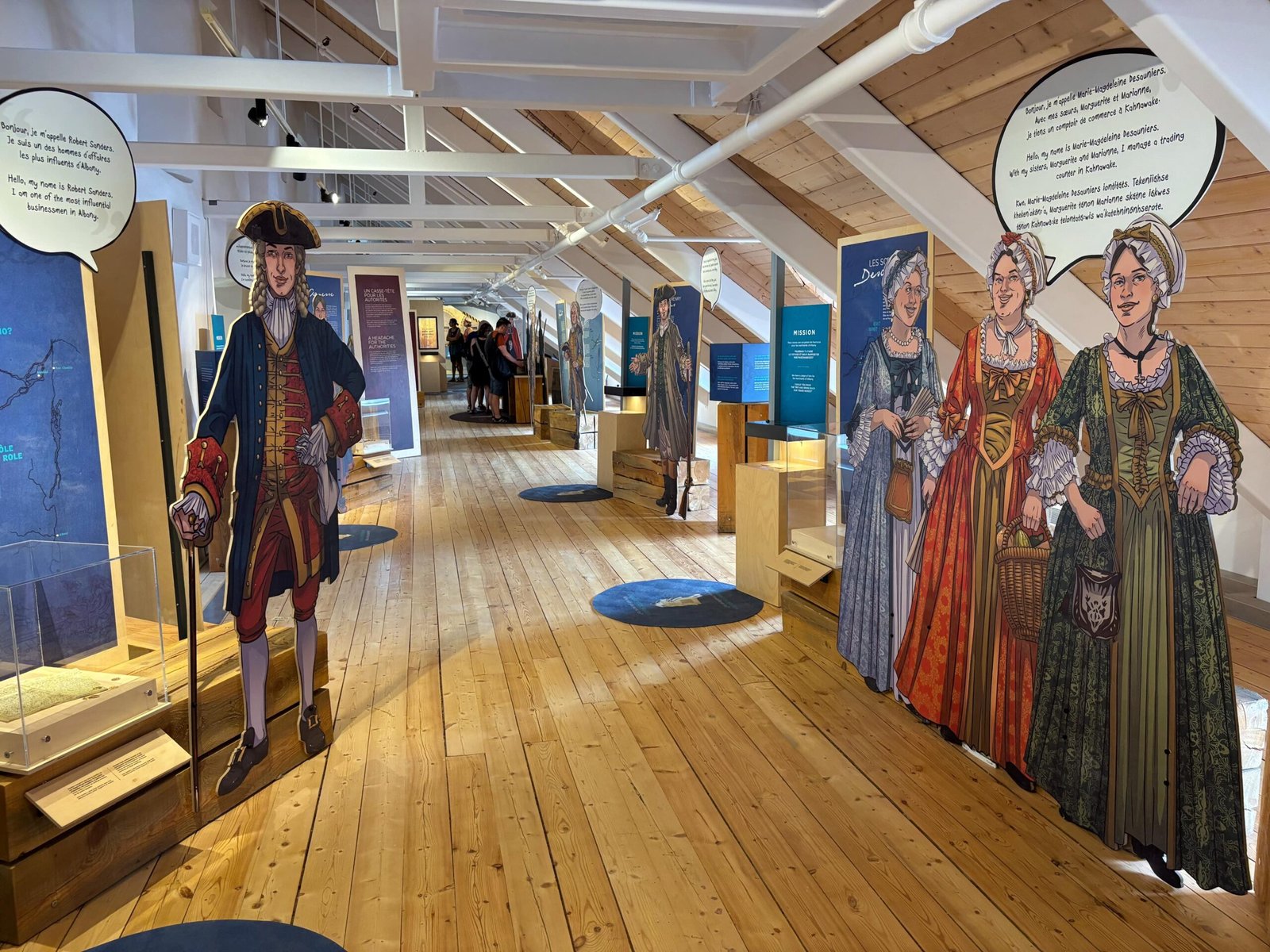 Life-size cutouts of French officers and women in period clothing at Fort de Chambly exhibit.