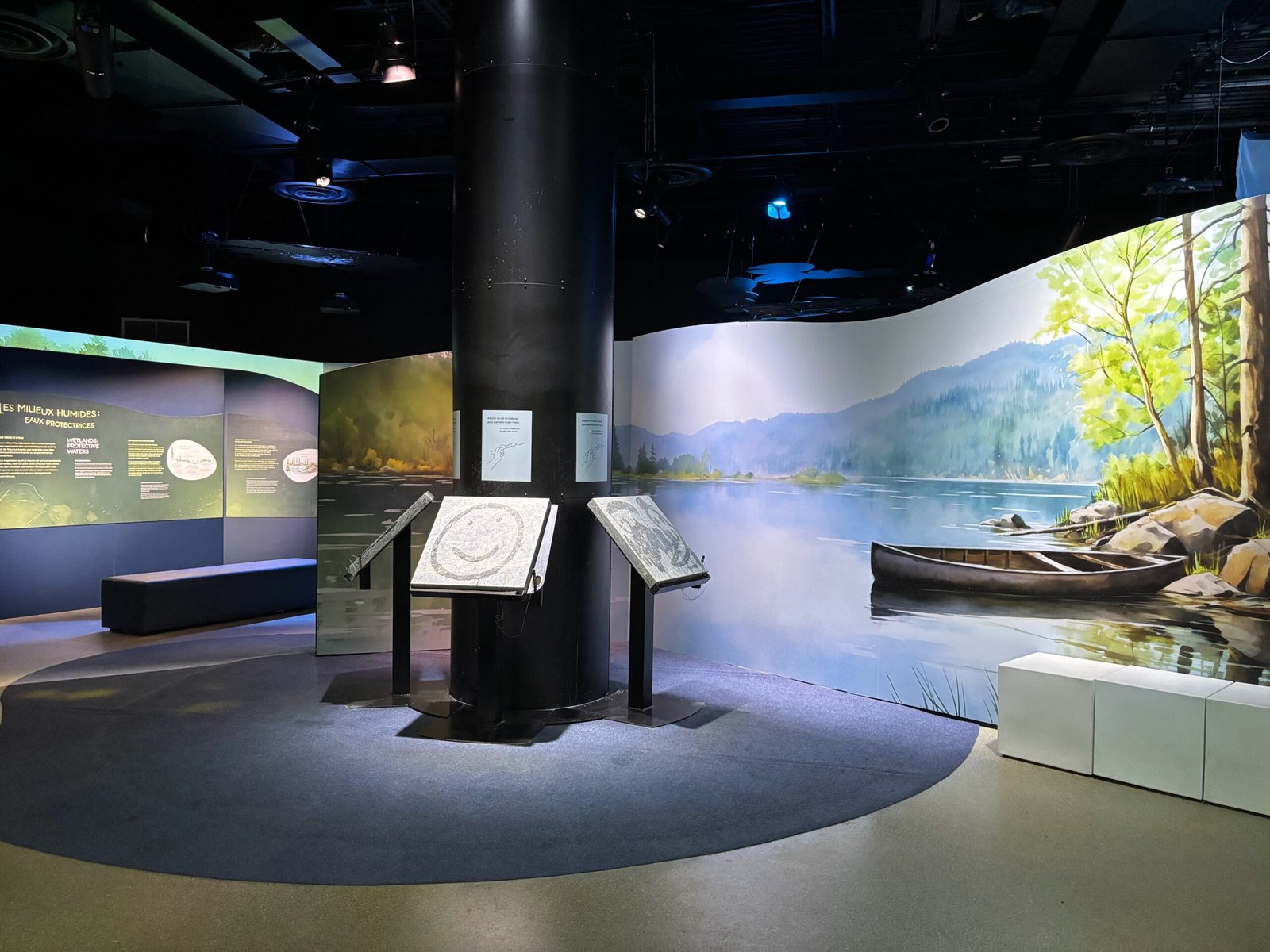 Large conservation exhibit on wetlands and rivers with painted nature backdrop at Biosphere Montreal.