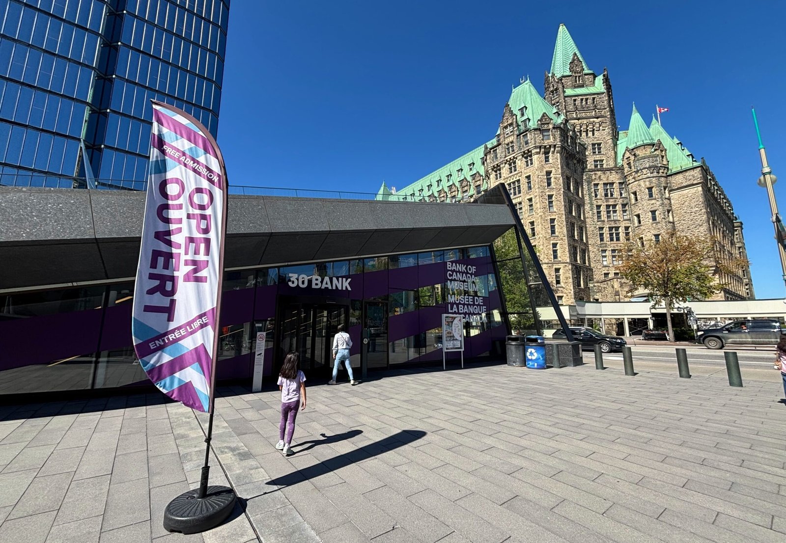 Exterior entrance of the Bank of Canada Museum with “Open / Ouvert” flag at 30 Bank Street, Ottawa.