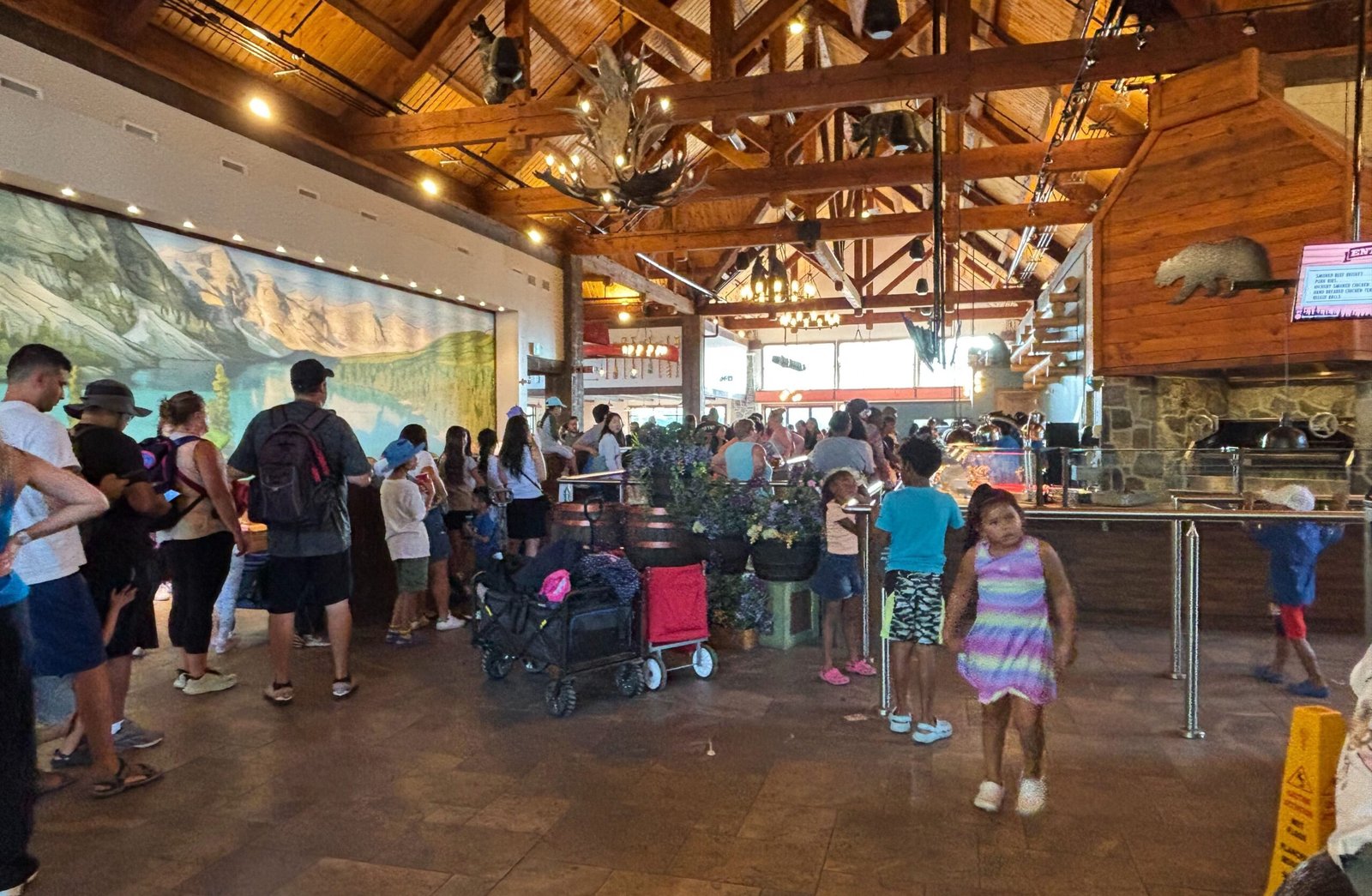 Families waiting in line at a rustic lodge-style restaurant at Canada’s Wonderland.