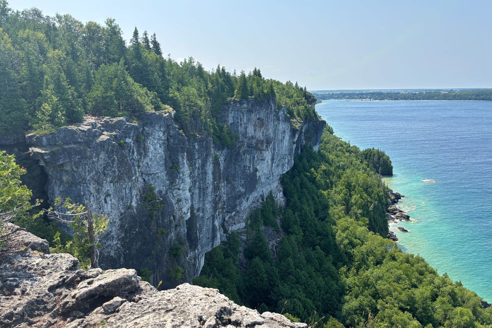 Sheer limestone cliffs of the Niagara Escarpment at Lion’s Head, rising above the turquoise waters of Georgian Bay.