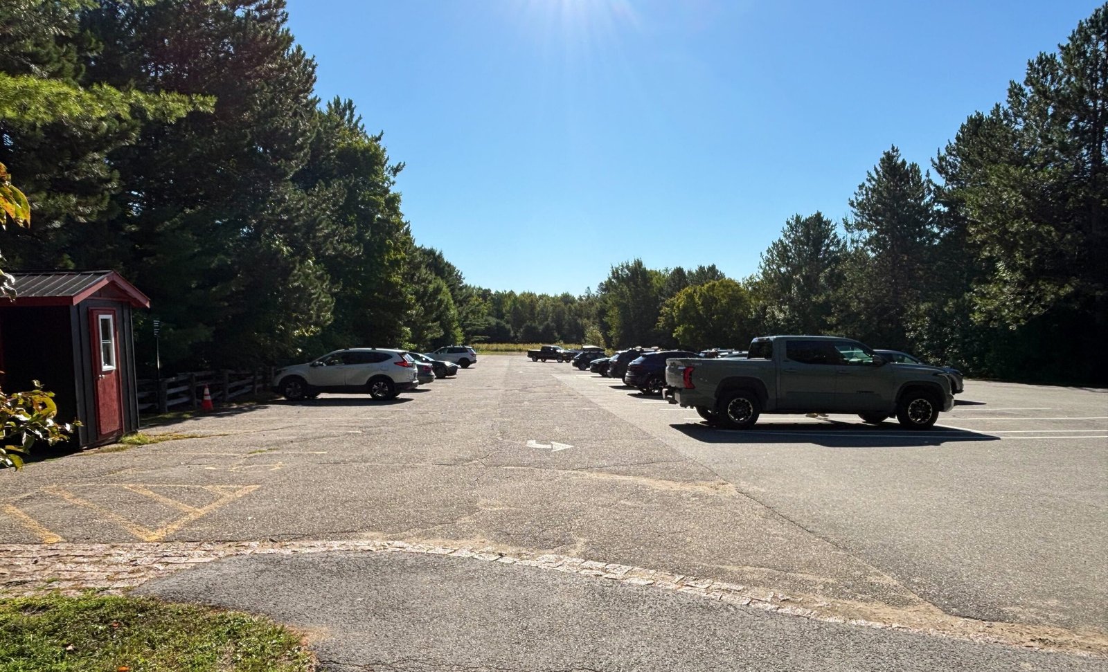 Parking lot at Carbide Willson Ruins trailhead in Gatineau Park on a sunny day.