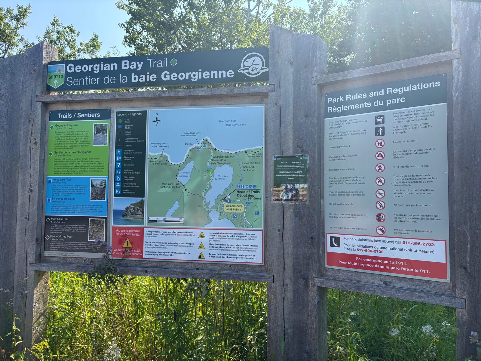 Information board for Georgian Bay Trail in Bruce Peninsula National Park, showing trail routes, regulations, and map to the Grotto.