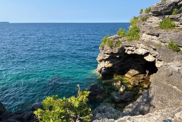 Rocky cave opening at the Grotto in Bruce Peninsula National Park, with turquoise water entering the cavern.